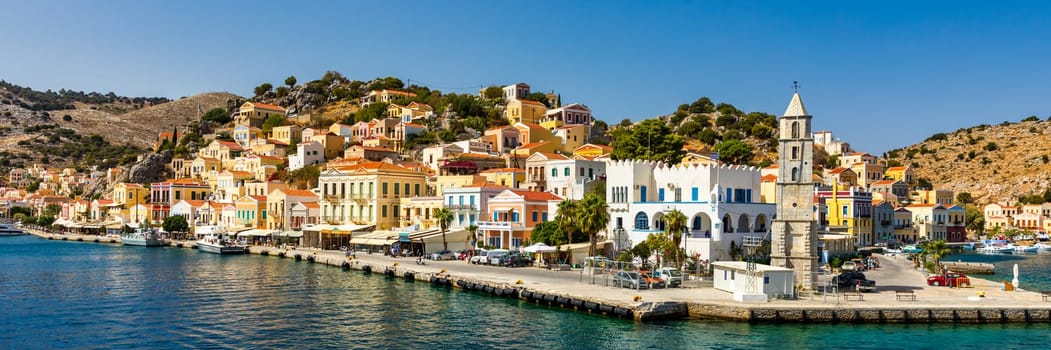 View of the beautiful greek island of Symi (Simi) with colourful houses and small boats. Greece, Symi island, view of the town of Symi (near Rhodes), Dodecanese.