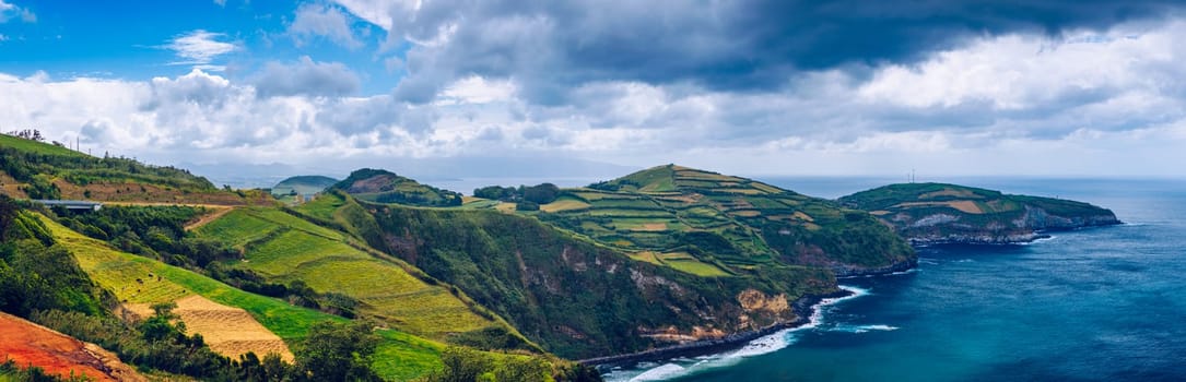 View from Miradouro de Santa Iria on the island of São Miguel in the Azores. The view shows part of the northern coastline with cliffs and green fields on the clifftop. Azores, Sao Miguel, Portugal