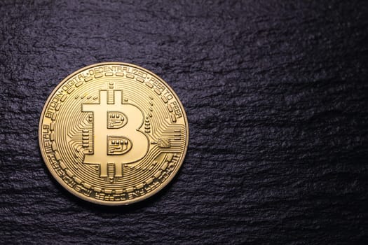 Bitcoin gold coin on dark textured background. Bitcoin & Cryptocurrency. Bitcoin. Crypto currency Gold Bitcoin, BTC, Bit Coin. Macro shot of Bitcoin coins isolated on black background.