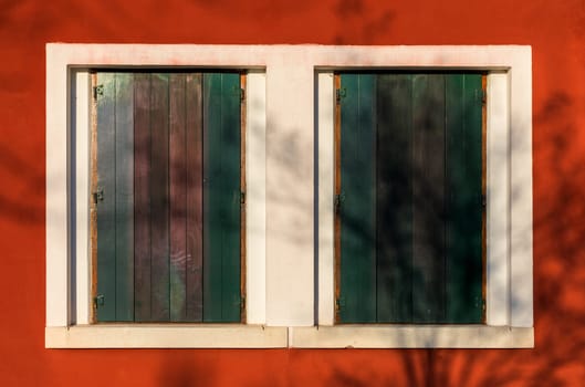 Colorful window of a house on the Venetian island of Burano, Venice. Facade of the houses of Burano close-up. Venice, Italy.