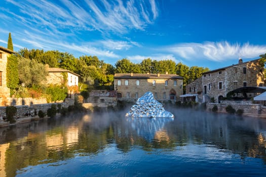 Thermal bath town of Bagno Vignoni, Italy during sunrise. Old thermal baths in the medieval village Bagno Vignoni, Tuscany, Italy. Medieval thermal baths in village Bagno Vignoni, Tuscany, Italy 