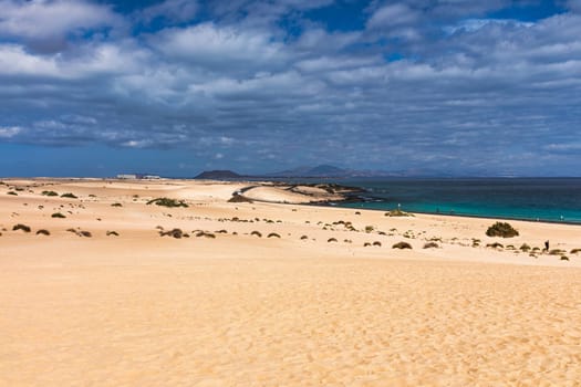 Sand dunes, Las Dunas de Corralejo, Corralejo Natural Park, dramatic cloud formation, Fuerteventura, Canary Islands, Spain. Sand dunes landscape, Corralejo, Fuerteventura, Canary Islands, Spain.