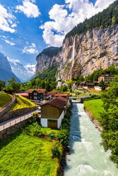 Famous Lauterbrunnen town and Staubbach waterfall, Bernese Oberland, Switzerland, Europe. Lauterbrunnen valley, Village of Lauterbrunnen, the Staubbach Fall, and the Lauterbrunnen Wall in Swiss Alps.