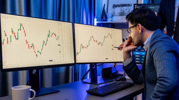 Stock exchange traders looking on high profit chart investment in panorama view, analyzing on monitor at night. Concept of discussing financial technology growth in neon light at workplace. Sellable.