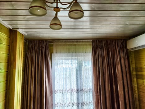 Beautiful curtains on the window with tulle, thick curtains and the sky in the background. Abstract texture, frame, place for text and copy space. The interior of the apartment