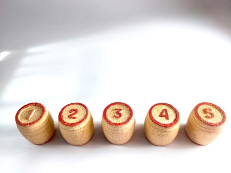 Small wooden barrels with numbers built in row. The concept of progressive movement in achieving the goal