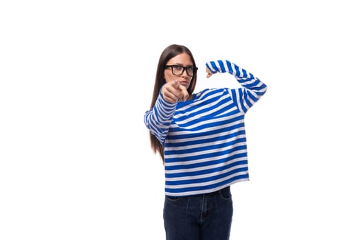 portrait of a charming young slender caucasian woman with straight dark hair in a blue sweater.