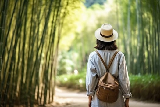 Eco travel and responsible tourism. Asian woman walking at Bamboo Forest, rear view. AI Generated