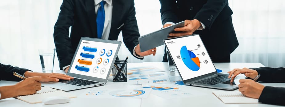 Business people in group meeting in formal attire share idea discussing report for company profit in creative workspace for start up business shot in close up view on group meeting table . Oratory .