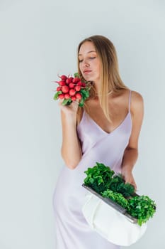Woman holding with vegetables in hands for eating radish