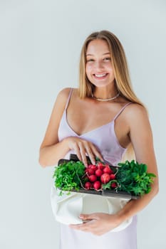 Female holding bag with vegetables for eating