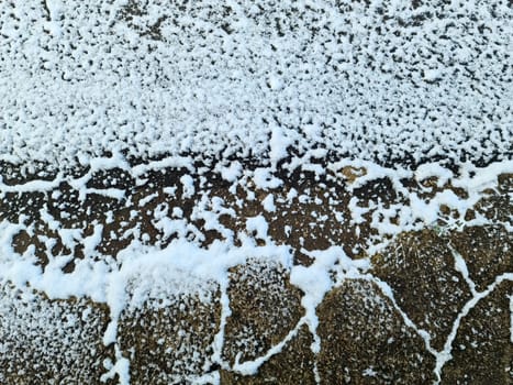 Snow on asphalt on a small german road.