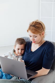 woman with son online on computer at home