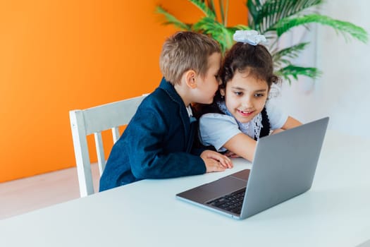 Boy and girl studying at the computer online