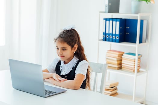 Girl engaged in computer online school