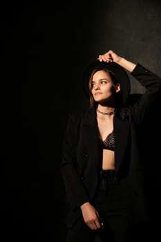 Woman in black clothes posing in room