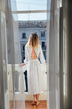 woman stands on the balcony in the room
