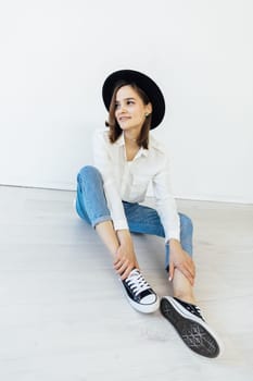 Woman in hat posing in studio