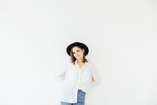 Woman in hat posing in studio