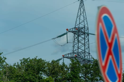 High voltage towers with sky background. Power line support with wires for electricity transmission. High voltage grid tower with wire cable at distribution station. Energy industry, energy saving.