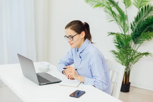 woman secretary in office working online on computer