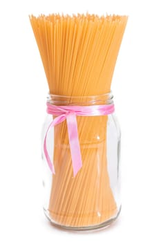 Dry Uncooked Spaghetti in a Glass Jar Isolated on White Background. Raw Pasta - Isolation