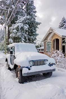 Snow piling on streets of Vancouver, Canada. A car covered with snow on the street.