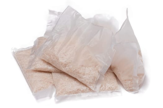 A Plastic Bags of White Long Grain Rice - Isolated on White Background. Small Transparent Packages with Dry Rice - Isolation