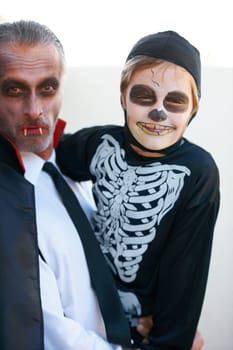 Portrait, halloween and costume with a father and his son outdoor for a trick or treat tradition together. Family, horror or spook with a parent and child in an outfit for celebration in the holidays.