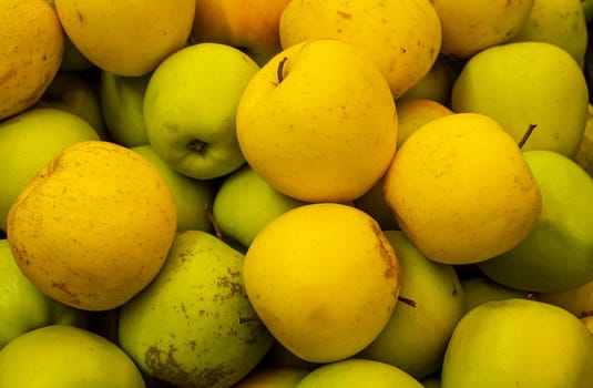 background of green and yellow apples in a fruit market. background of apples of different colors