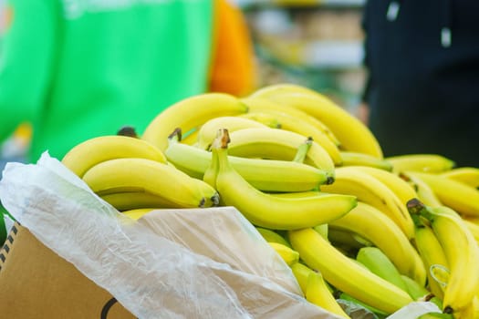 Fresh yellow bananas in close-up on the shelves of a hypermarket.