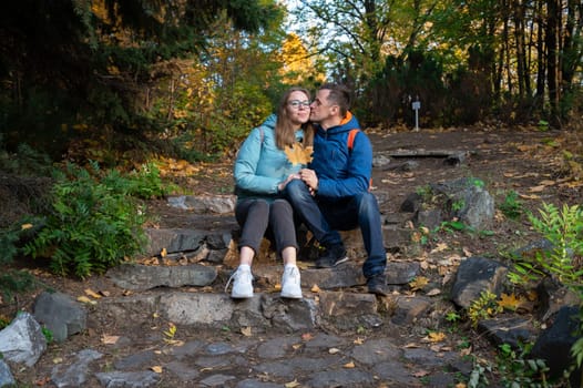Happy couple in autumn park on fall nature background