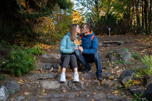 Happy couple in autumn park on fall nature background