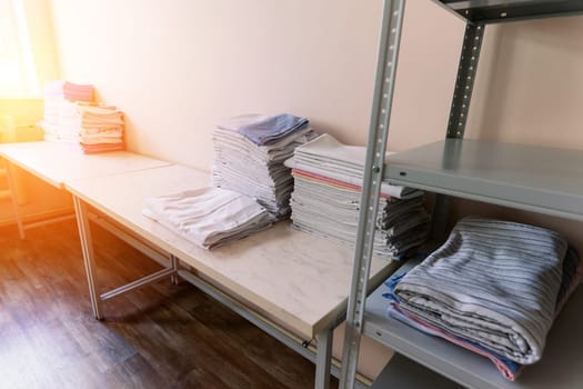 Sanitary prevention antivirus concept. Fresh White Hotel Towels Folded and Stacked on Shelf