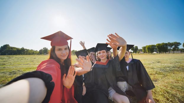 College alumni take selfies in the meadow