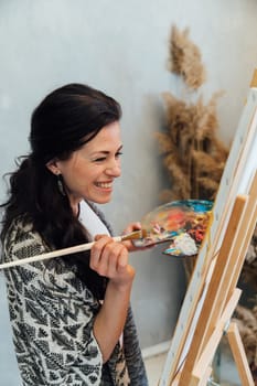 The artist emotionally paints a picture on an easel
