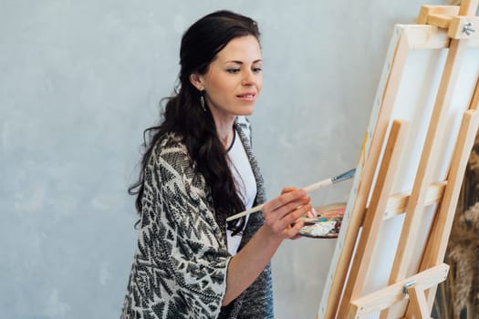 The artist emotionally paints a picture on an easel