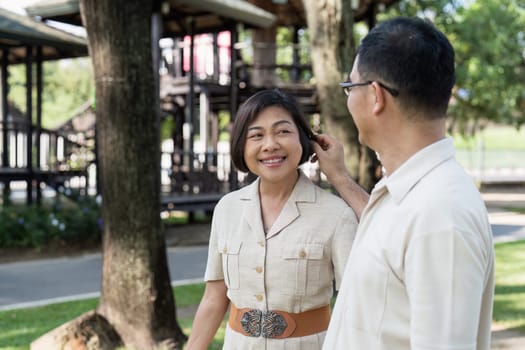 elderly married couple retired have a picnic together in the park. senior retired conceptual.