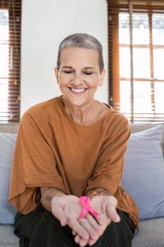 Pink October Breast Cancer Awareness month. woman senior with pink Ribbon for support people life and illness.