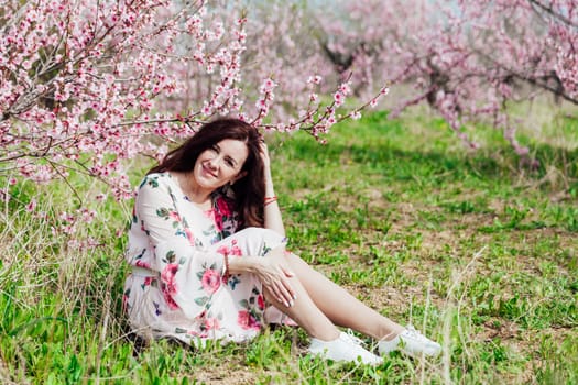 travel walk brunette woman in flowering trees spring nature