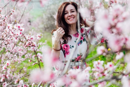 spring nature walk beautiful woman brunette in flowering trees