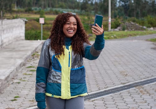 latina influencer making content on social media for her audience on a tourist trip with a big smile. High quality photo