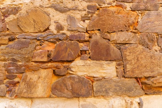 Background of an old wall made of red stone. Close-up, wall texture.