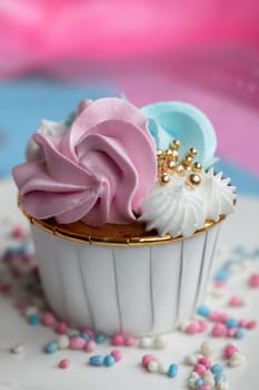 Cupcake blue and pink for gender party. boy or girl. delicious cupcakes with blue and pink cream, golden sparkles celebration concept when the gender of the child becomes known. Festive baby shower sweets concept close up