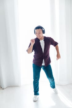 A man listens to music with headphones and dances