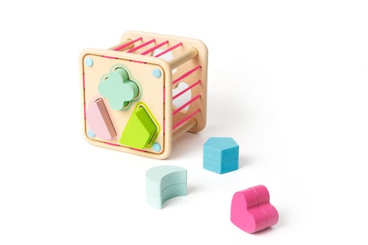 Wooden children's puzzle toy with colorful blocks of different shapes isolated on white background.