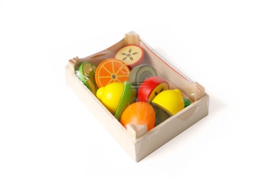 New educational set of wooden toys in the form of fruits and vegetables in a toy wooden box packed in polyethylene, isolated on white background.