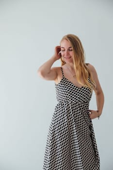 Portrait of beautiful blonde woman in light summer dress