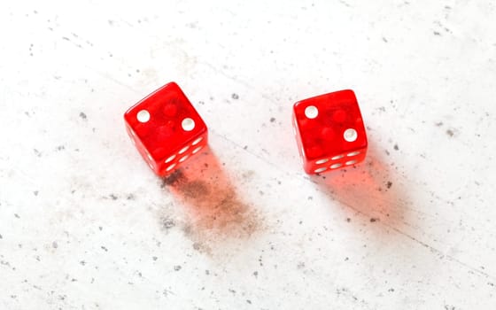 Two red craps dices showing Hard Four / Little Joe (double number two) overhead shot on white board