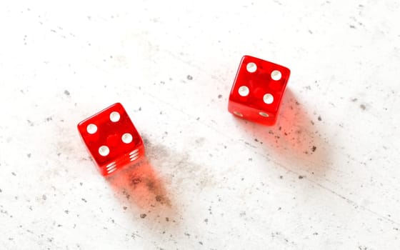 Two red craps dices showing Hard Eight from Decatur (double number four) overhead shot on white board